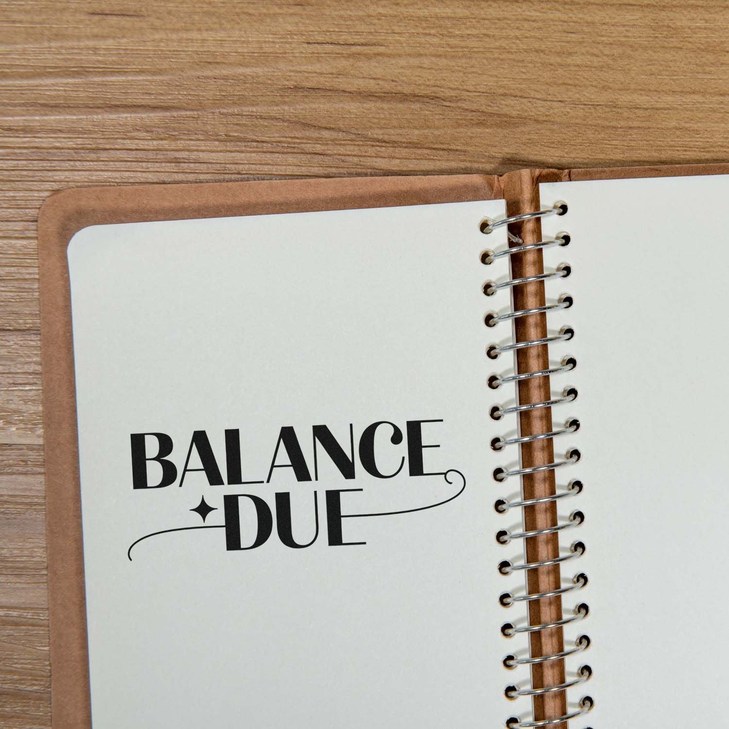 Balance Due rubber stamp on notebook page for invoice tracking and payment reminders