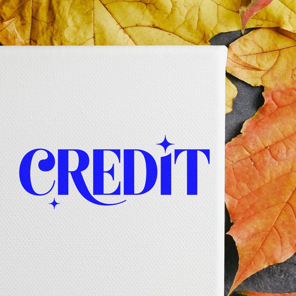 Blue CREDIT rubber stamp on white card, ideal for accounting, billing, and office document organization.