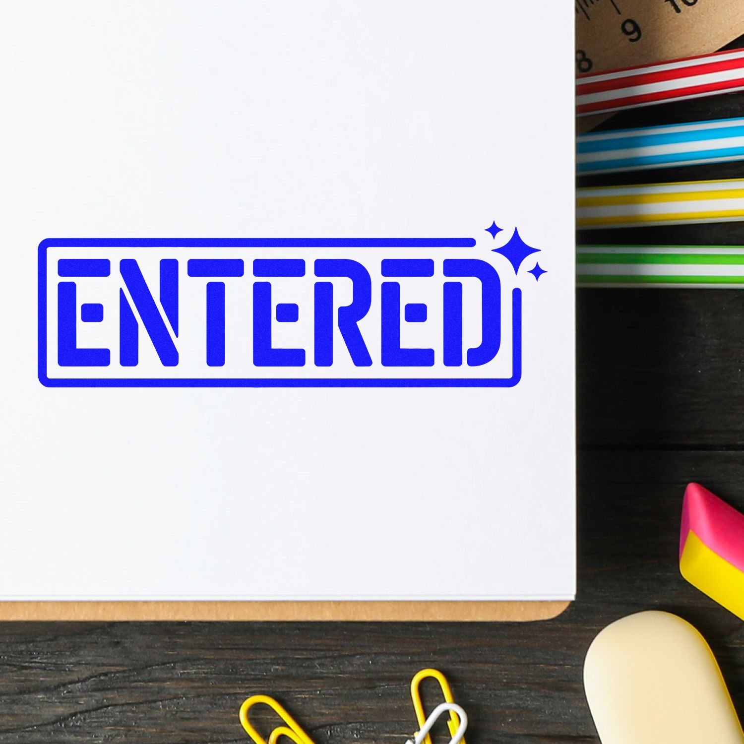 Blue ENTERED rubber stamp on document, used as an office approval and filing mark.