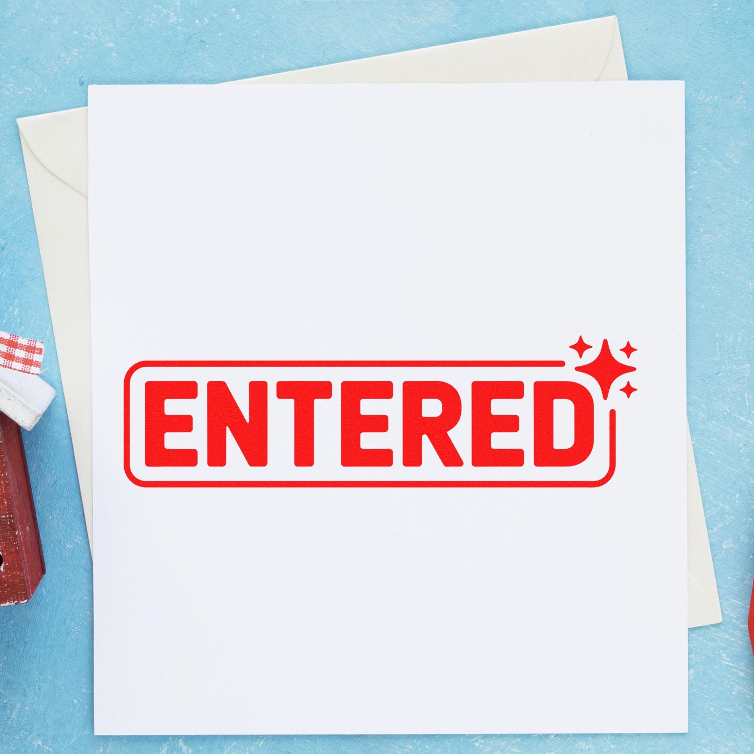 Red ENTERED rubber stamp on paper for office mail processing, document approval, and recordkeeping.