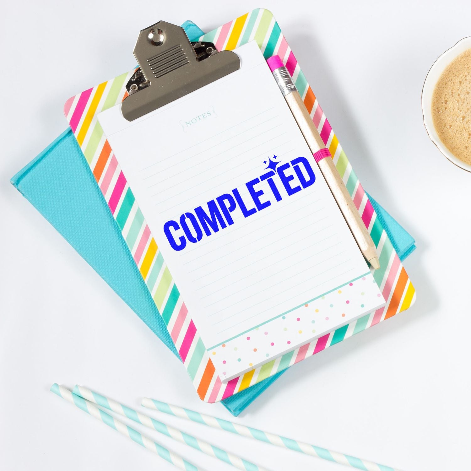 Completed rubber stamp on clipboard notepad for office task tracking and organization.