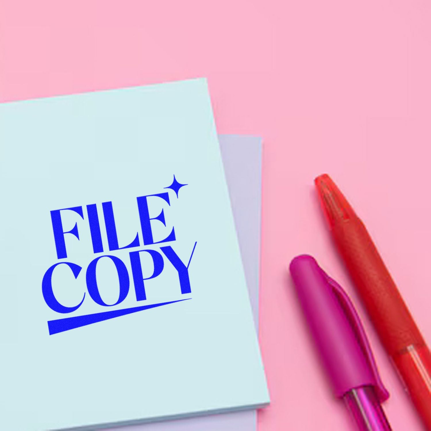 File copy rubber stamp on pastel paper with pens, ideal for office document organization and recordkeeping.
