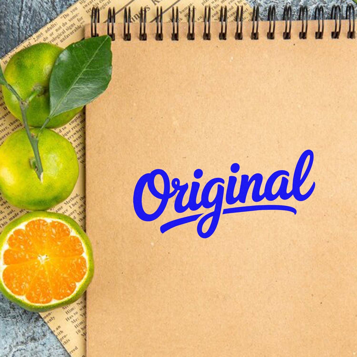 Original script custom rubber stamp design with citrus fruit accents on a kraft notebook page.