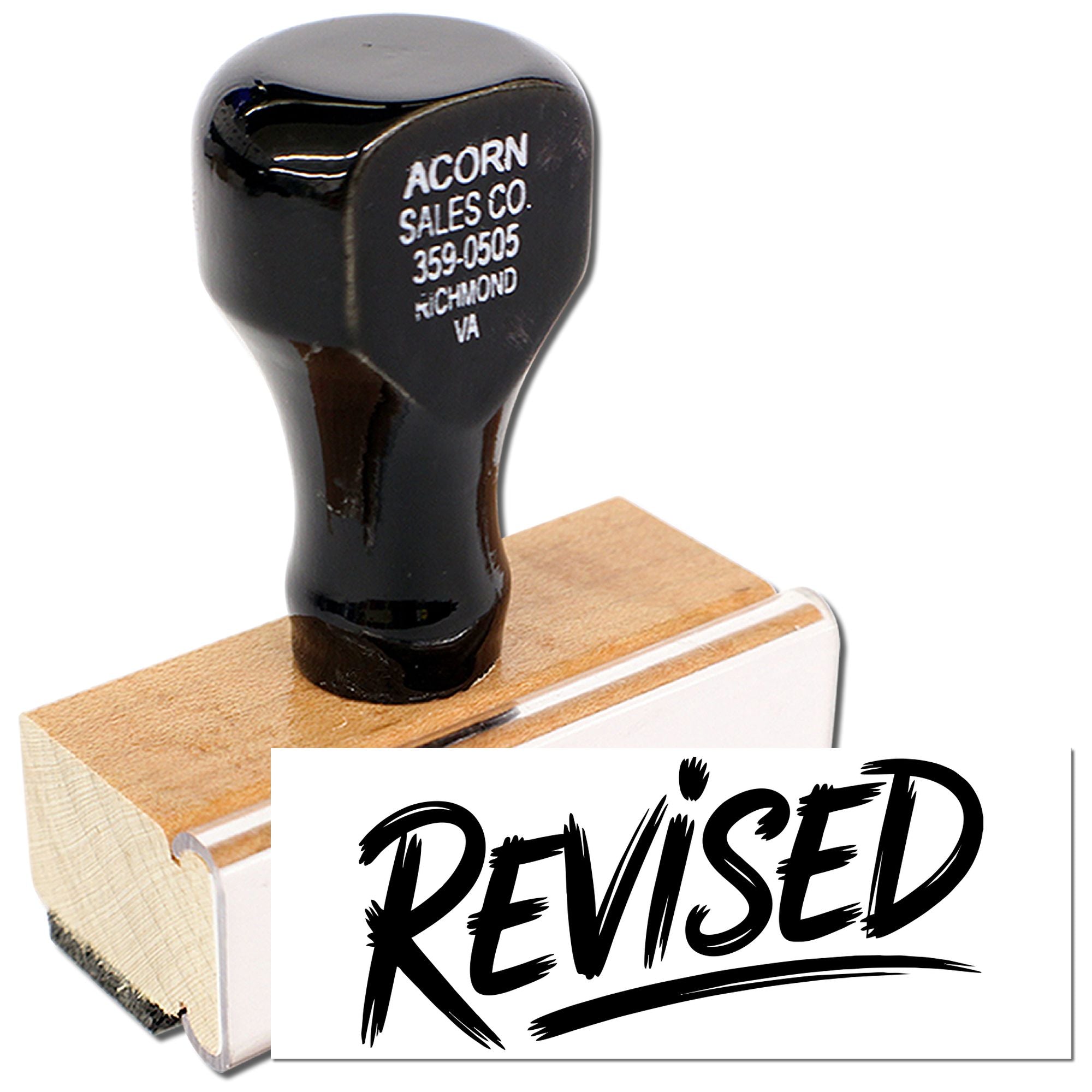 Wooden rubber stamp with bold REVISED imprint for marking office documents and forms.