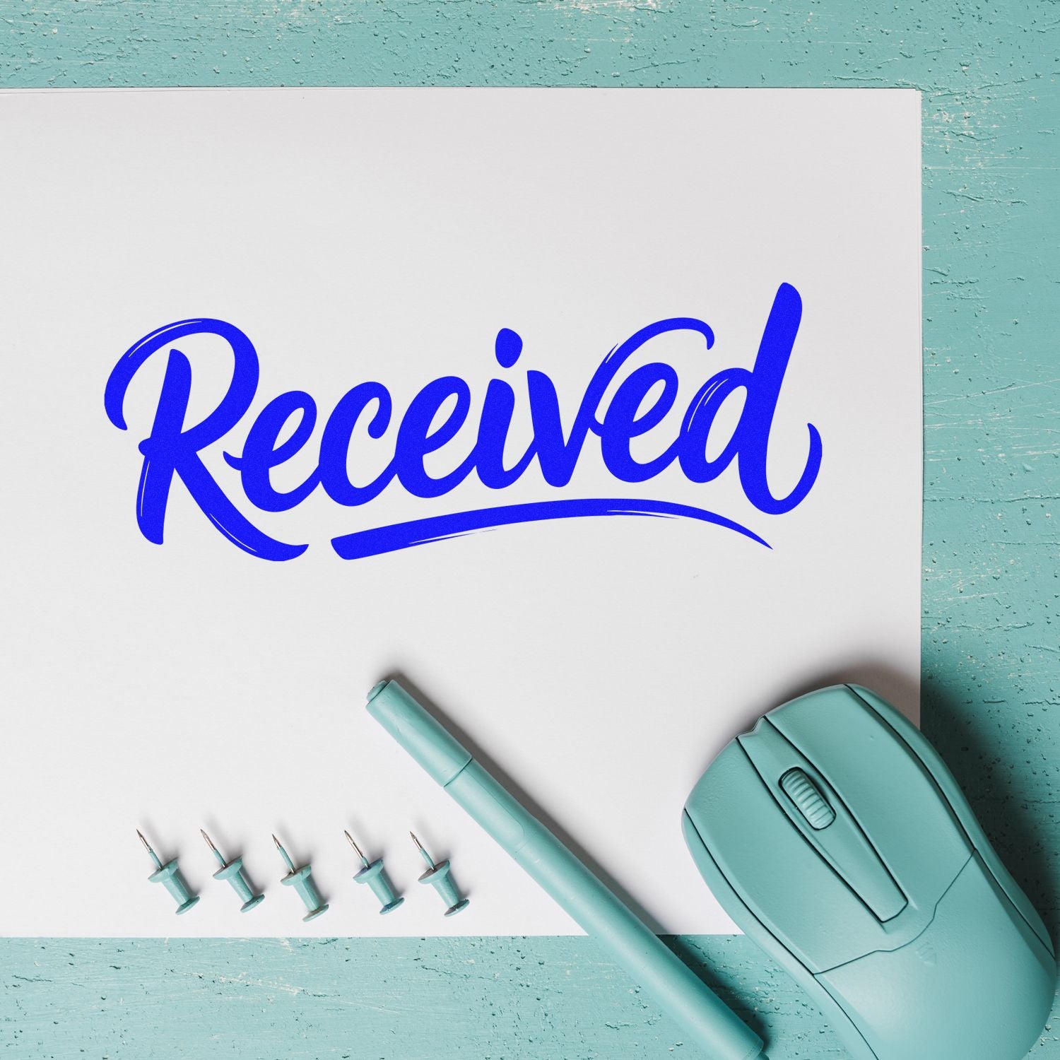 Blue Received rubber stamp imprint on white paper with teal stamp tool, ideal for office document approval and mail marking.