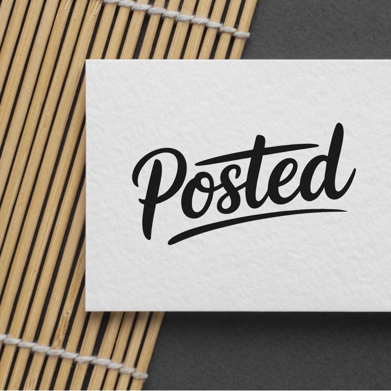 Posted rubber stamp impression on white paper over bamboo mat, ideal for custom office and mailing labels.
