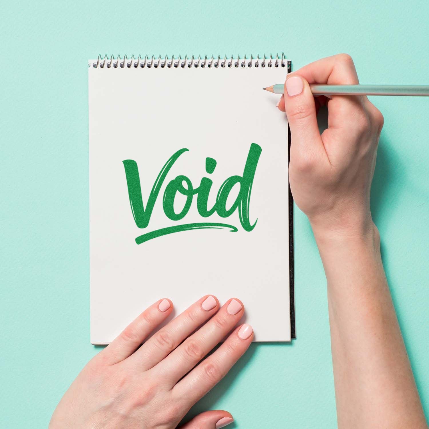 Green Void rubber stamp impression on notebook for custom office and craft branding.