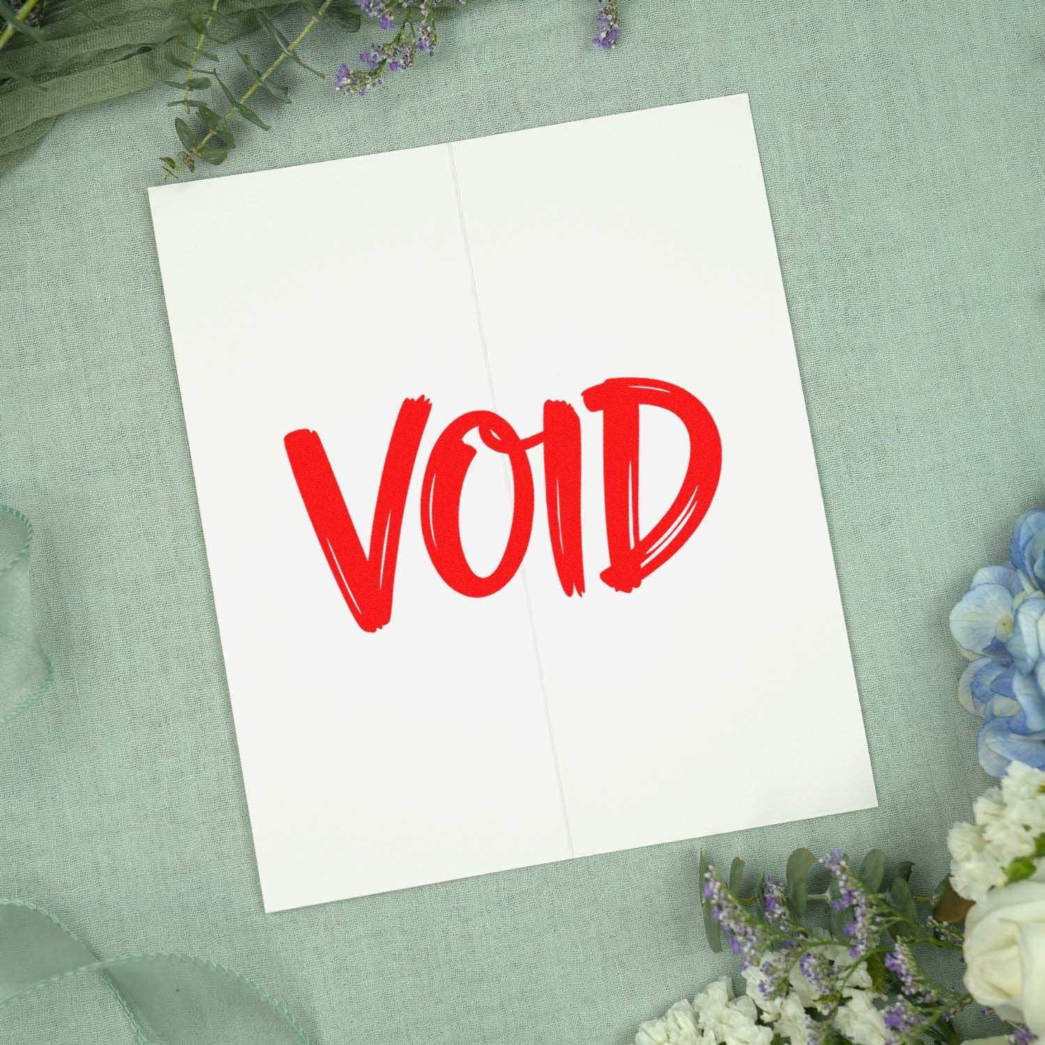 Red VOID rubber stamp impression on an open card, ideal for document cancellation, packaging, or office use.