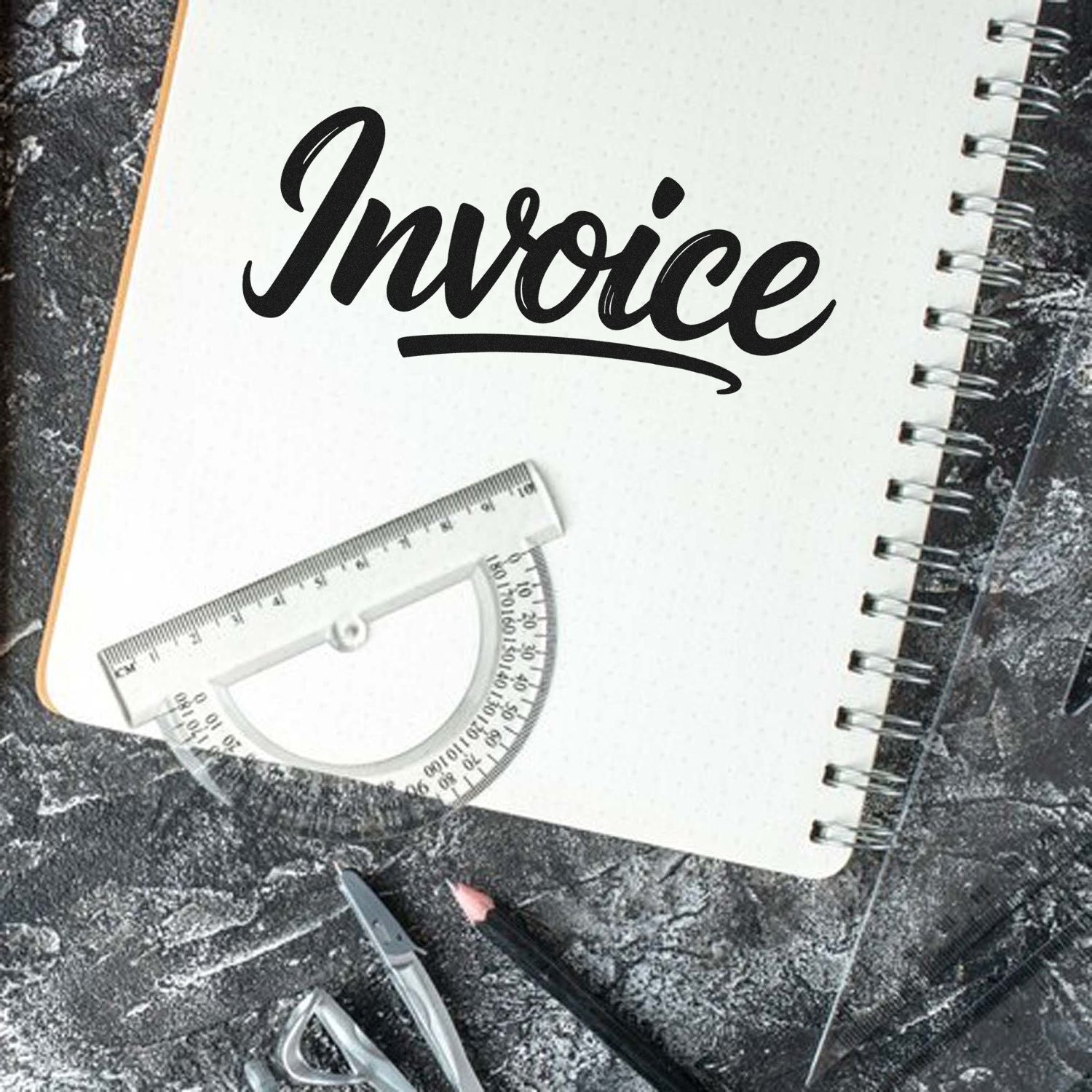 Custom invoice rubber stamp design on notebook, perfect for office bookkeeping, accounting, and document labeling.