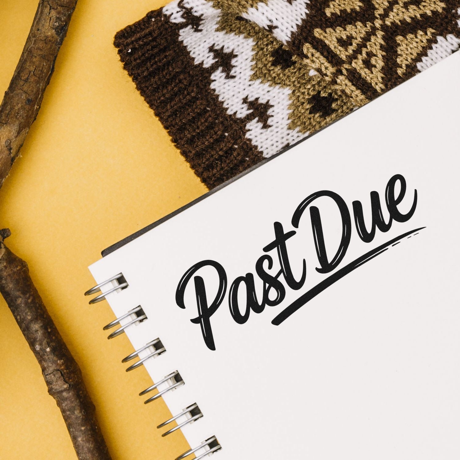 Rubber stamp reading Past Due on a spiral notebook, perfect for office reminders, billing, and organization.