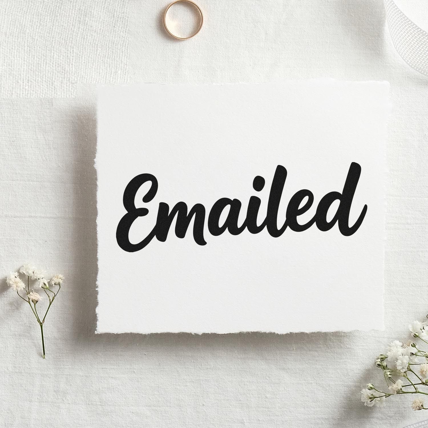 Custom Emailed rubber stamp impression in bold script for office mail, order processing, and business paperwork.