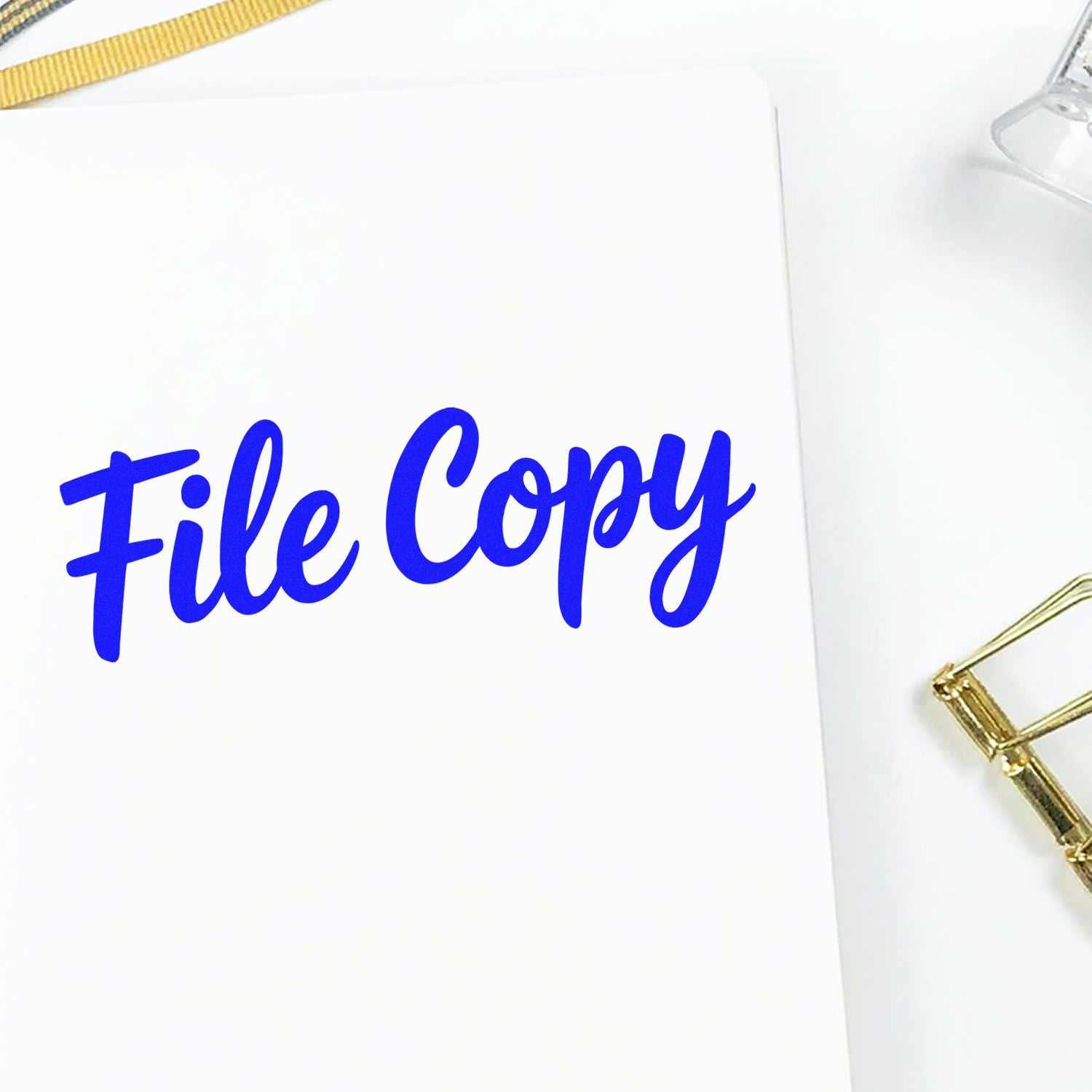 Blue File Copy rubber stamp on white paper for document organization and duplicate filing.