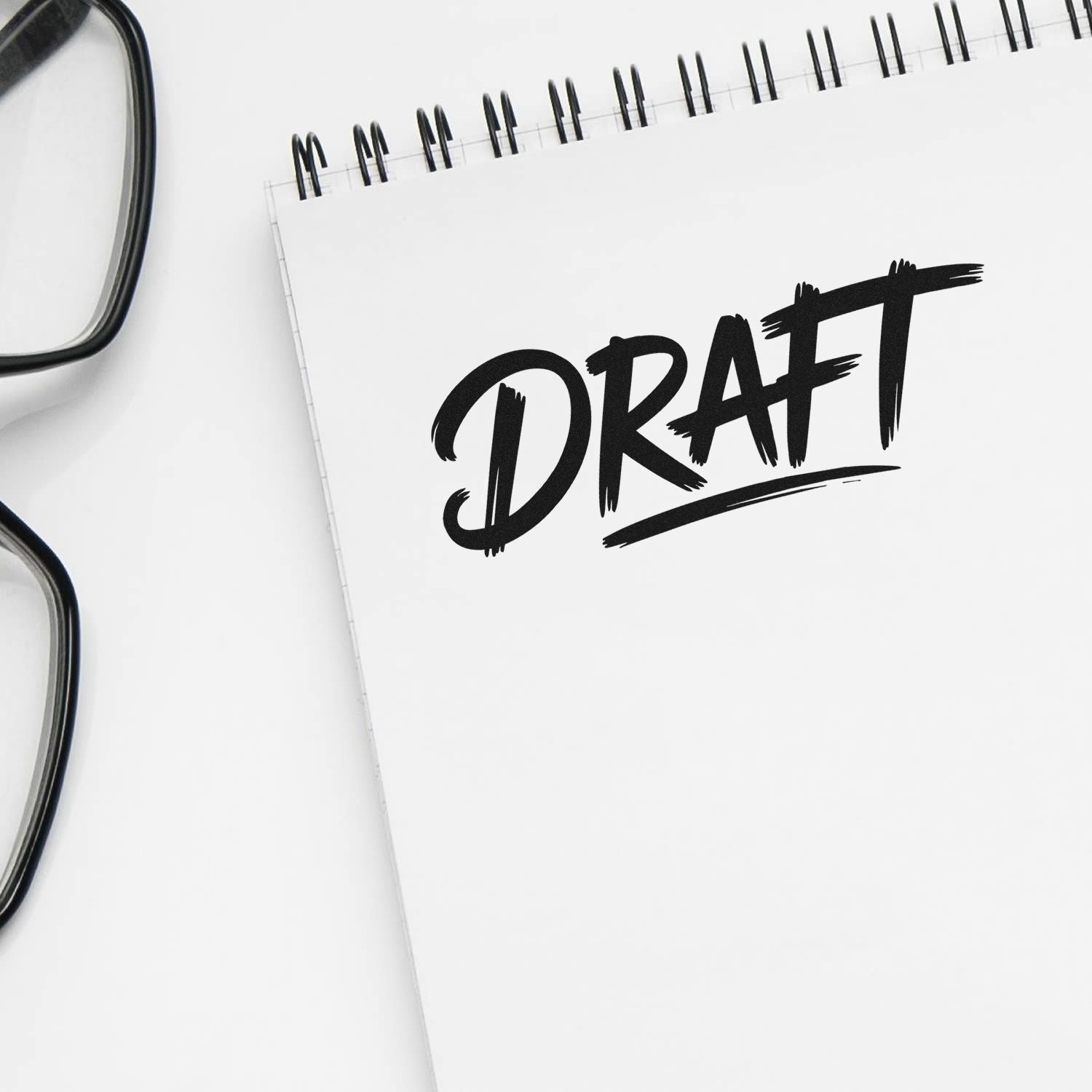 DRAFT rubber stamp impression on notebook, ideal for marking documents as draft or work-in-progress.