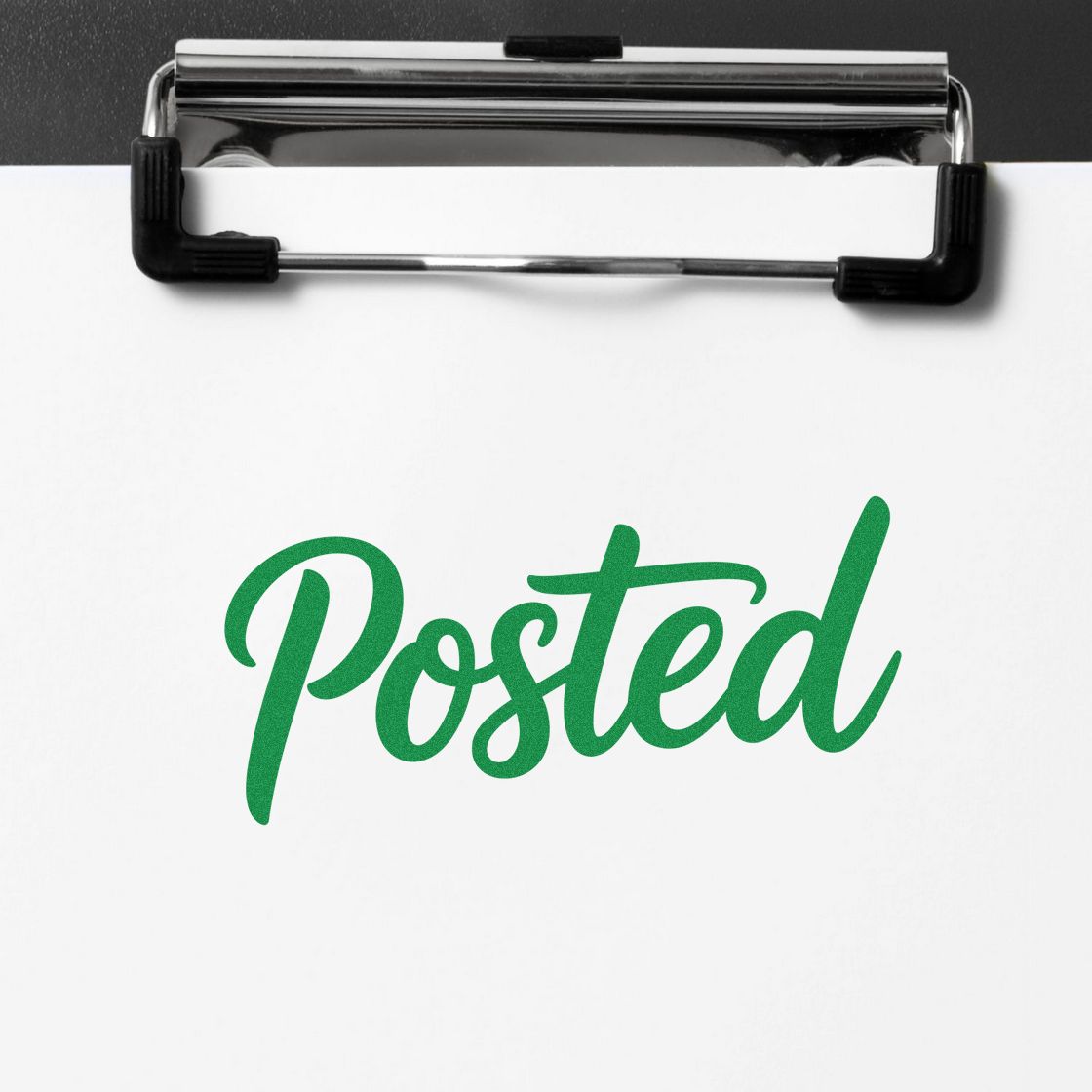 Green Posted rubber stamp imprint on clipboard paper for office mail, approval, or processing status.