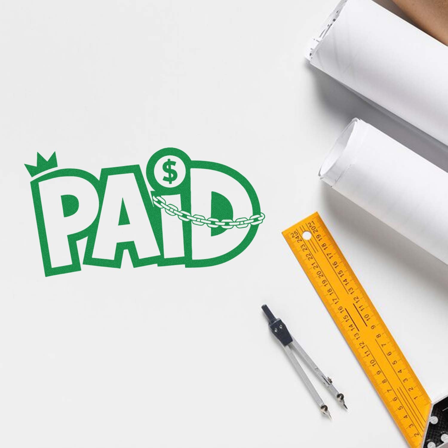 Green PAID rubber stamp design with dollar icon and chain, shown with office tools on a white background for business payment marking.