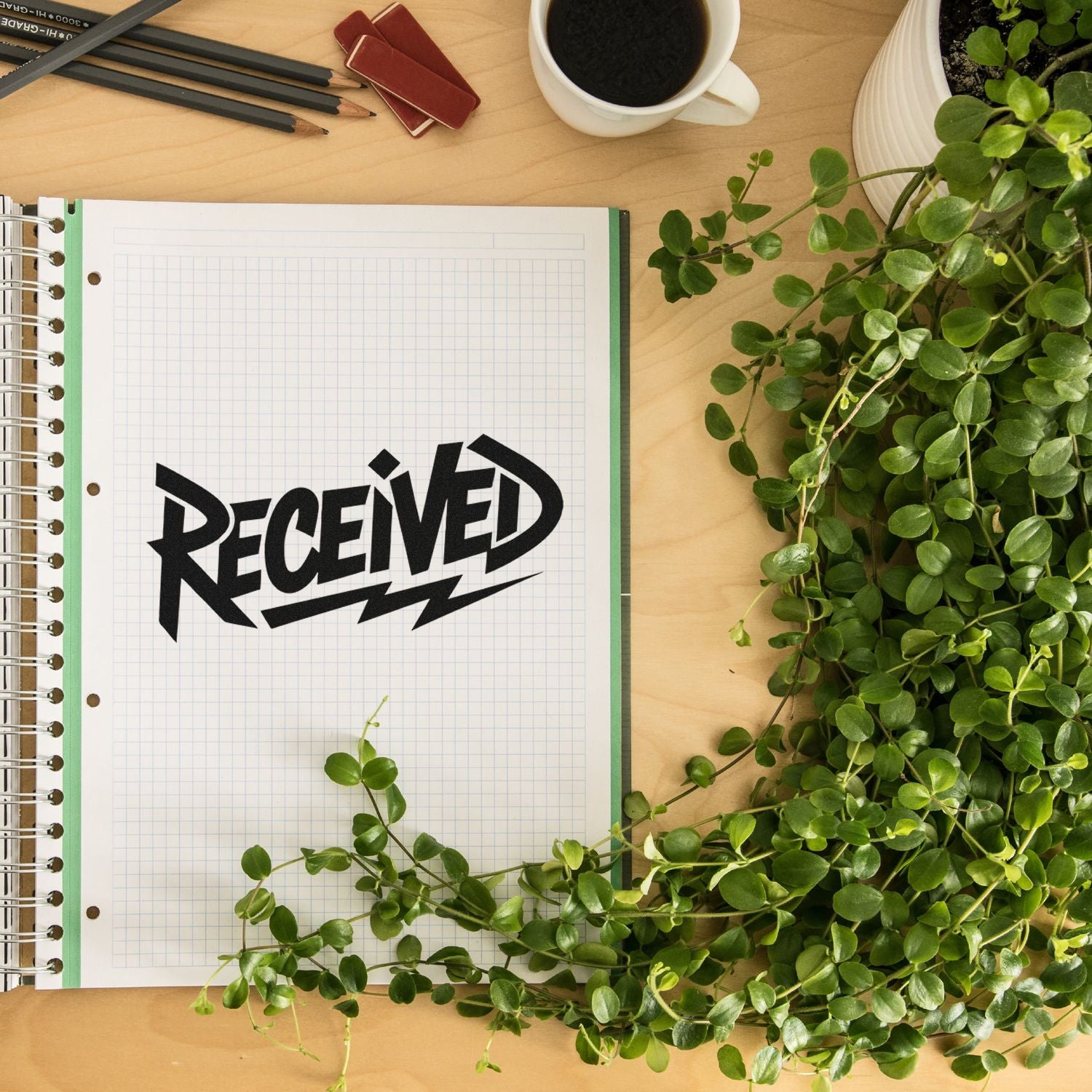Bold Received rubber stamp on notebook page for office paperwork, inventory, and mail processing.