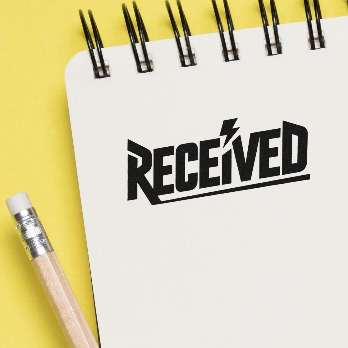 Received rubber stamp impression on notebook page for office mail, records, and document processing.