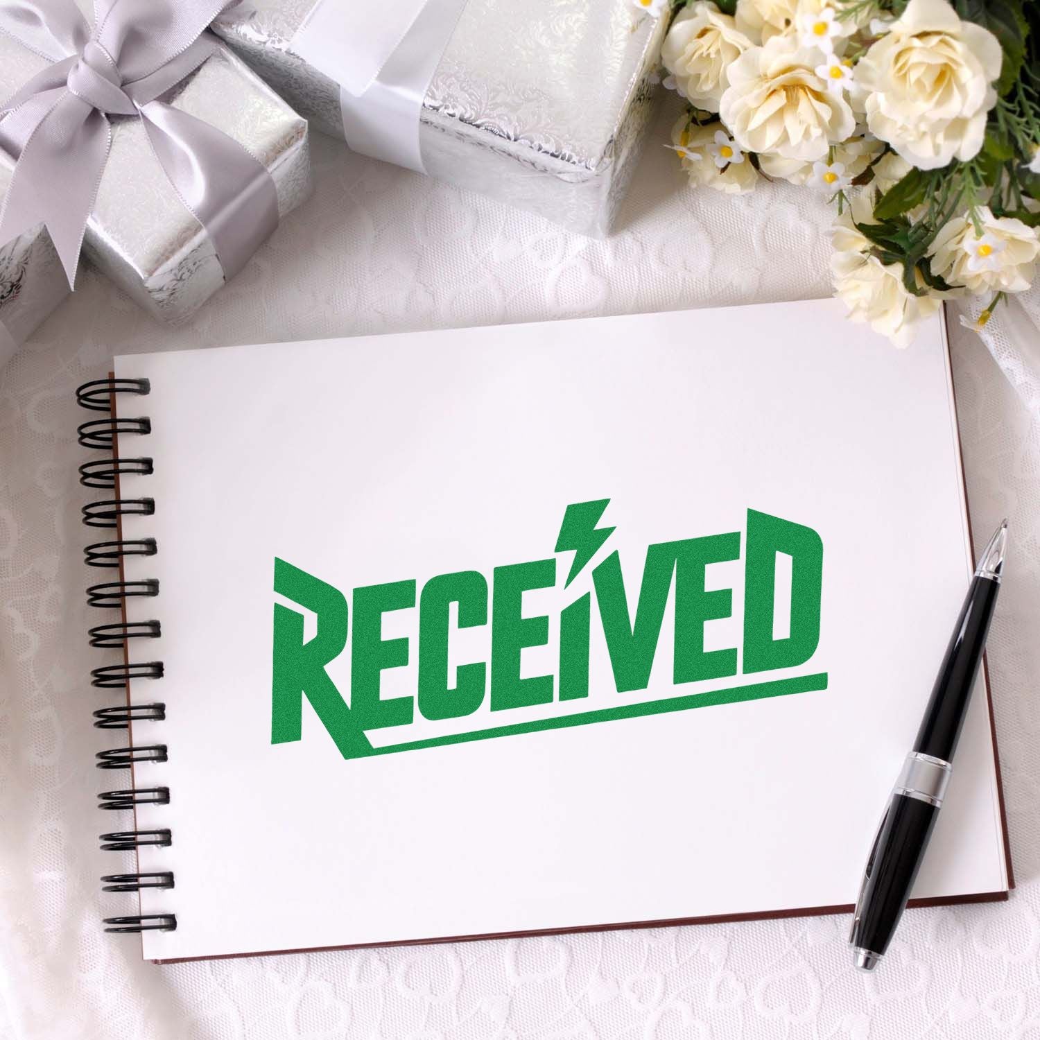 Green RECEIVED rubber stamp impression on notebook for office mail sorting, document processing, and package tracking.