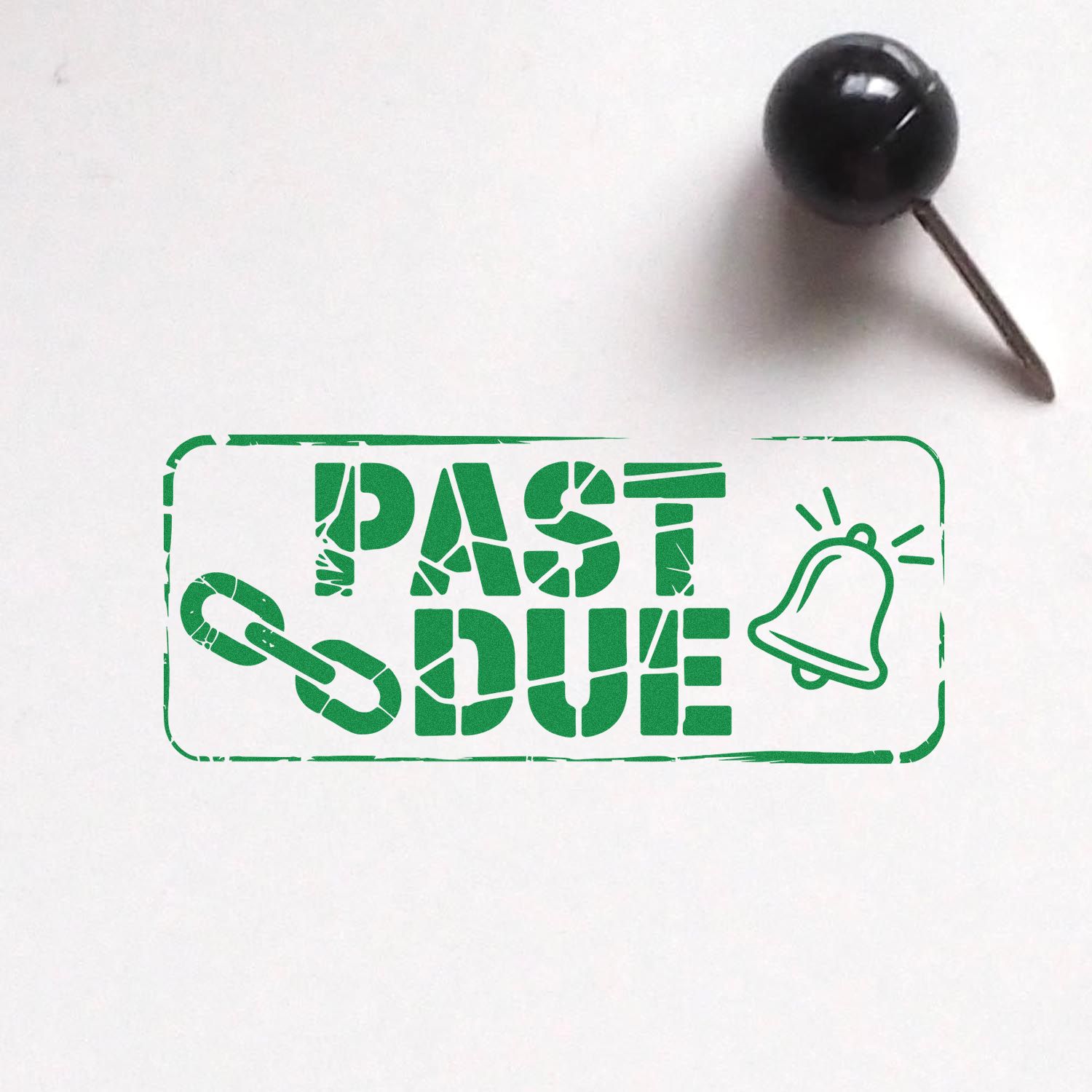 Past Due rubber stamp impression with chain and notification bell icon on white paper, shown with a black push pin.