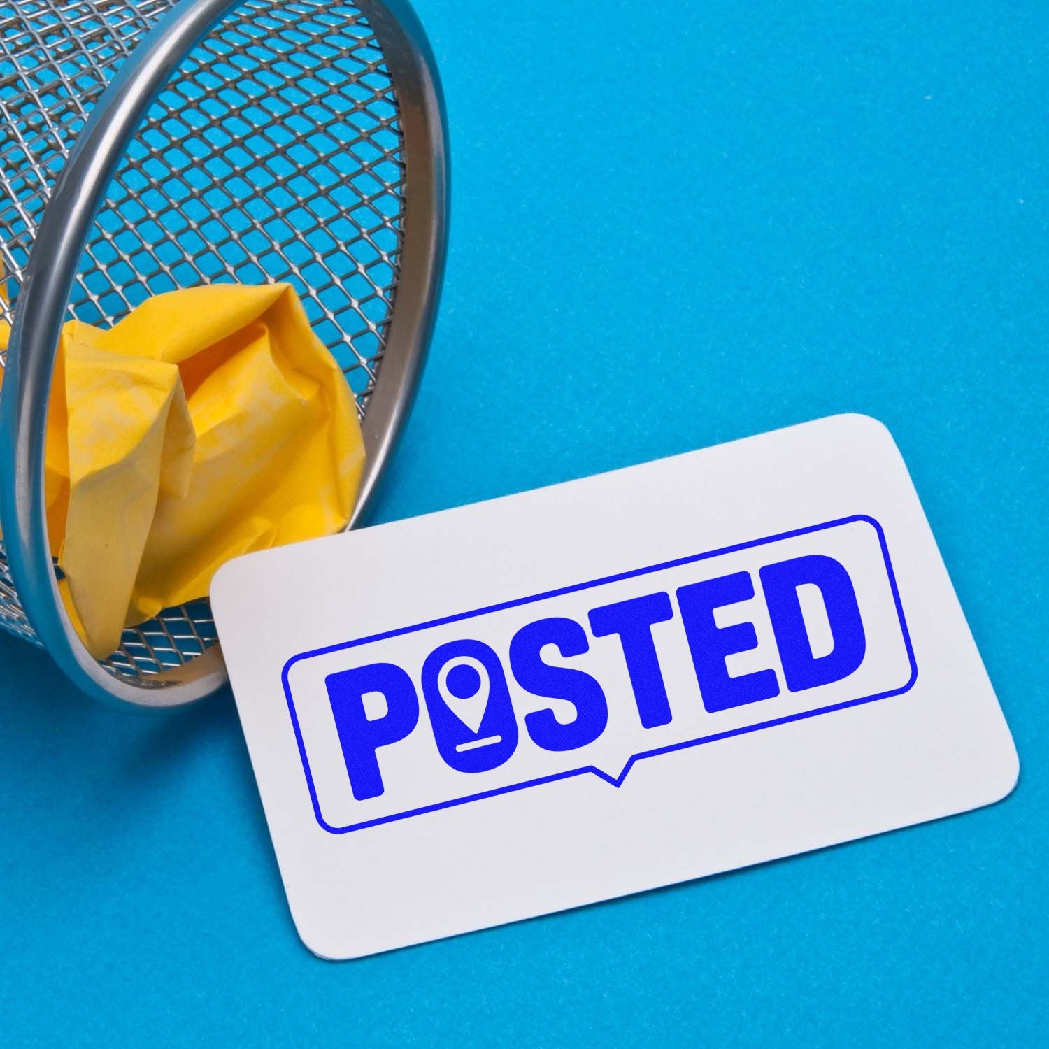 Posted rubber stamp on a card beside a mail basket, ideal for office mail handling, document approval, and shipping.