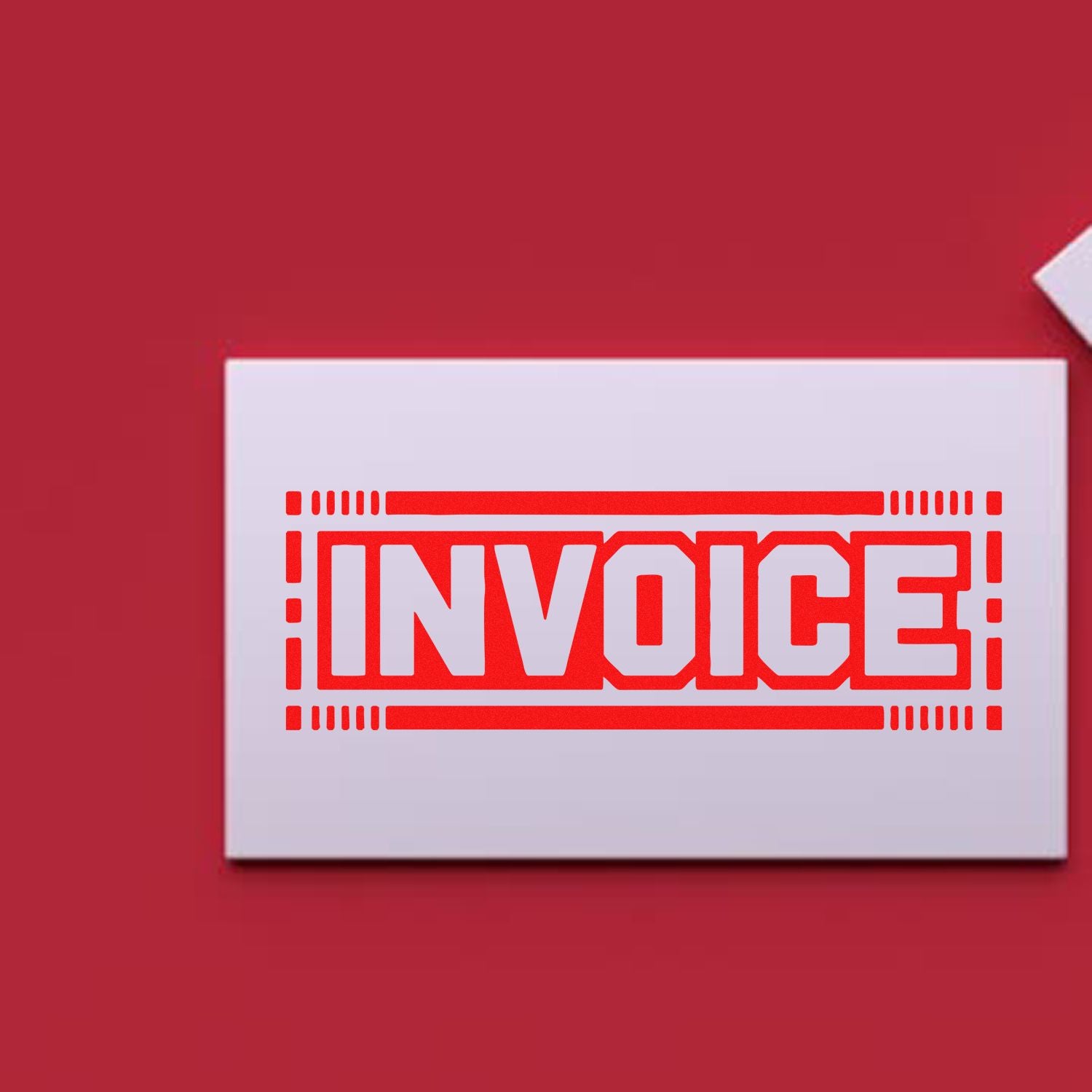Red invoice rubber stamp on a white card, ideal for accounting, billing, and office paperwork.
