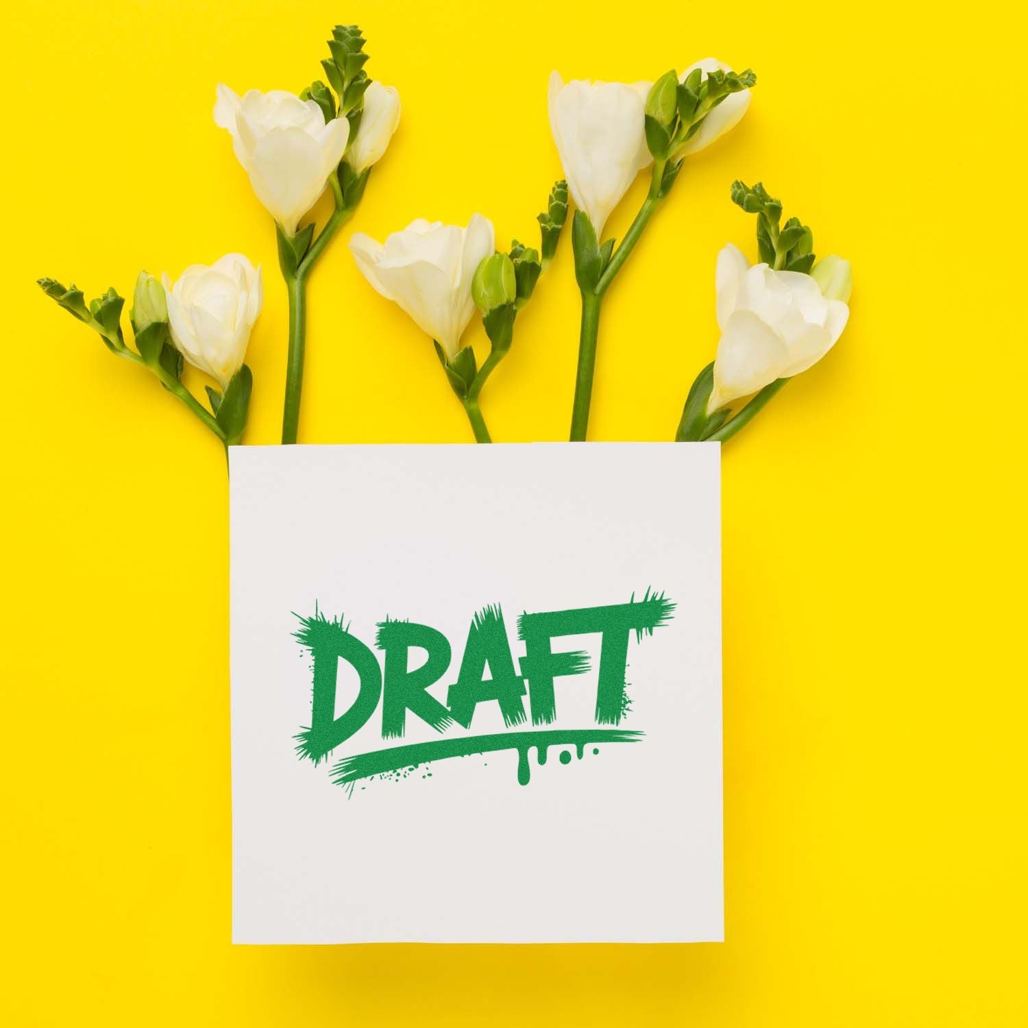 Draft rubber stamp design on paper with white flowers, ideal for document review and office approval branding.