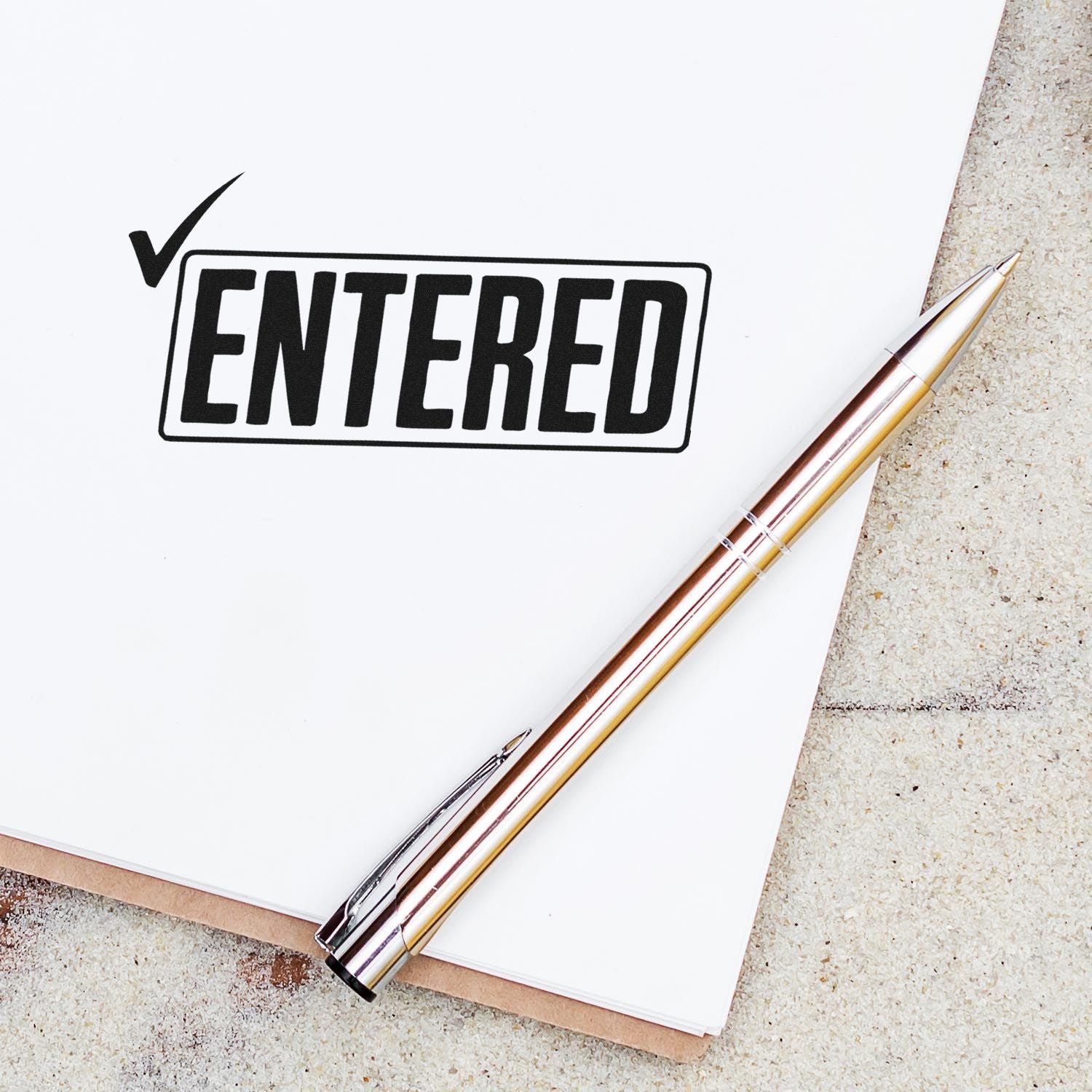 Entered rubber stamp on paper with checkmark, ideal for document processing, office approval, and recordkeeping.