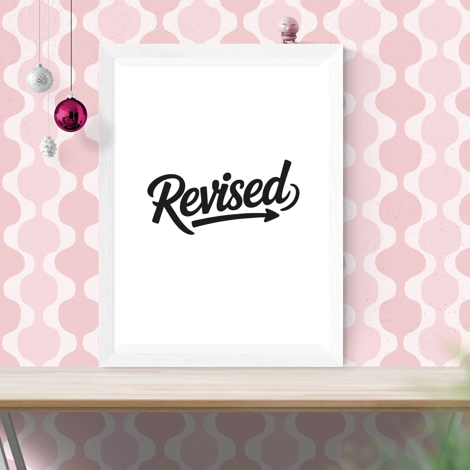 Revised rubber stamp design mockup with bold script text, displayed on a white frame for office document approval.