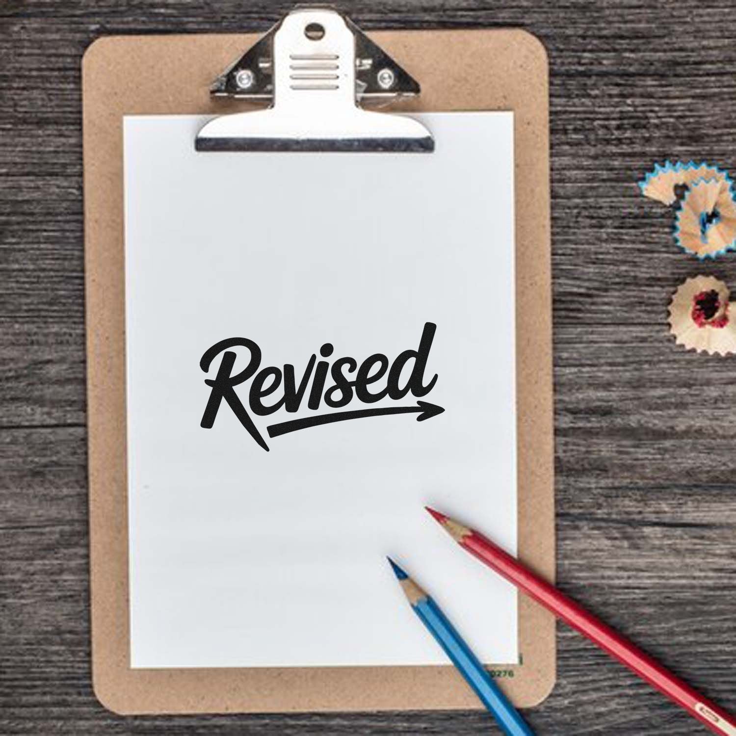 Revised rubber stamp mockup on clipboard, ideal for office documents, proofreading, and approval marking.