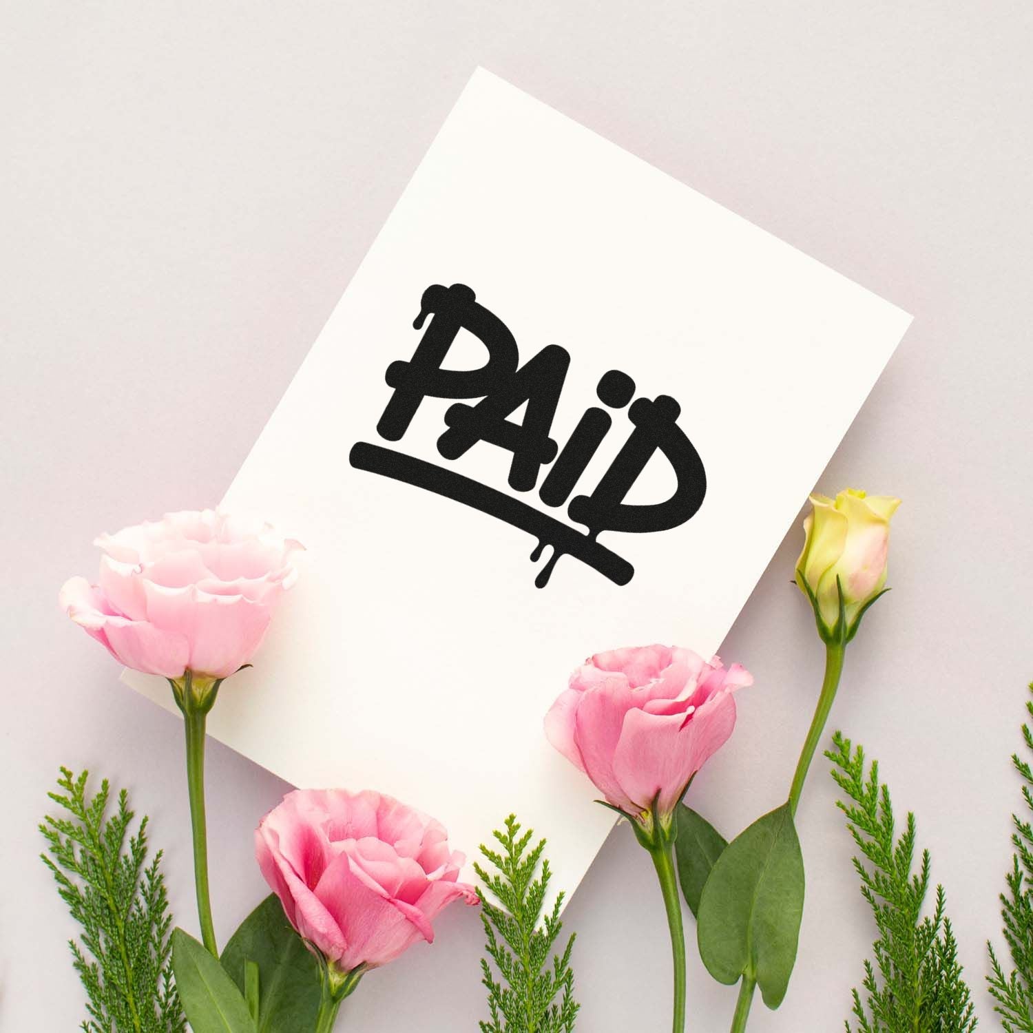Paid rubber stamp on white card, ideal for marking invoices, receipts, and business documents.
