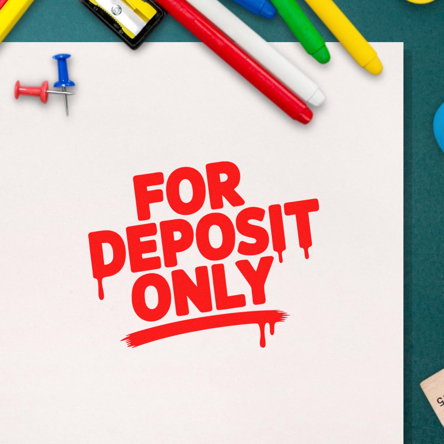 For Deposit Only rubber stamp imprint on paper with pens and push pins, ideal for banking and check endorsement.