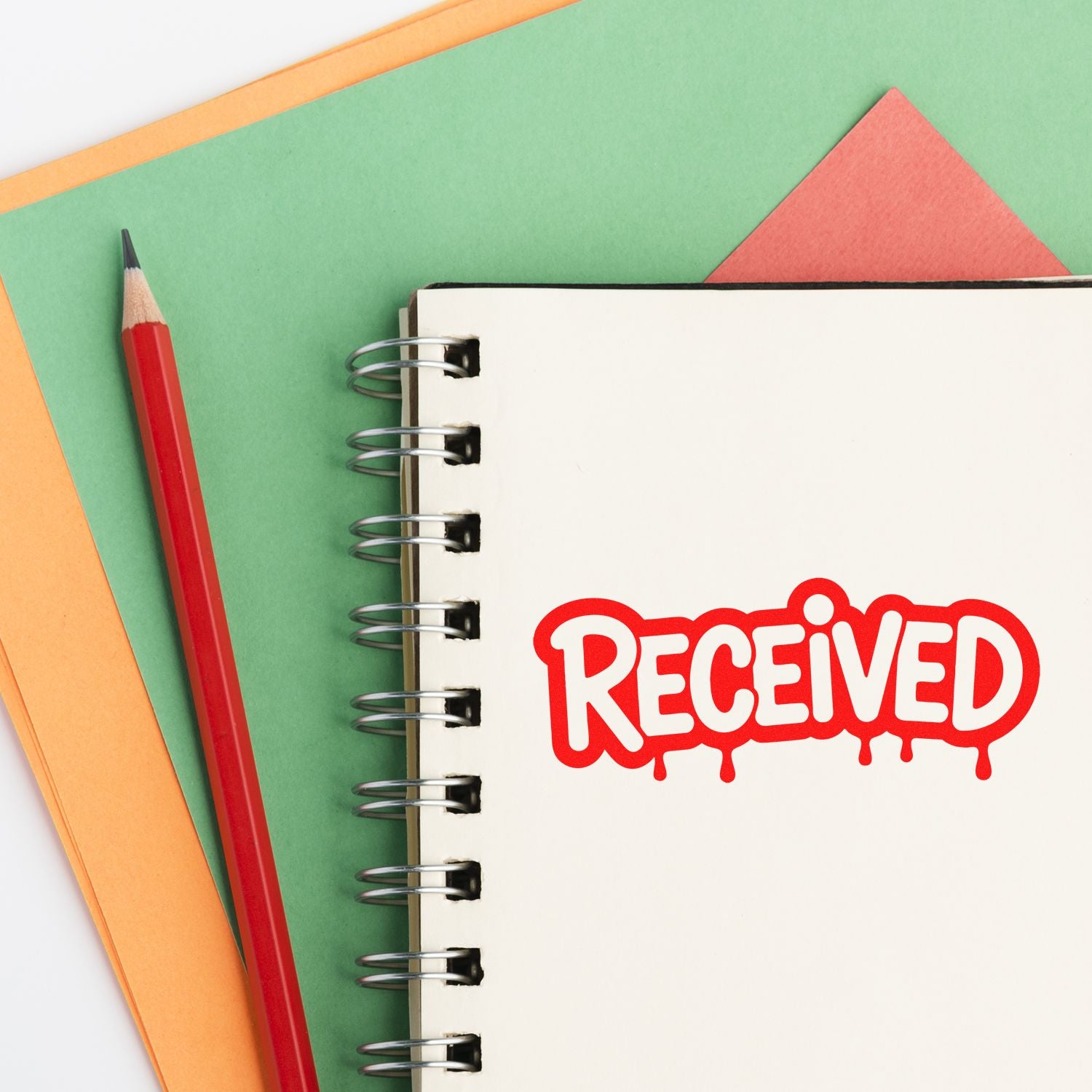 Red RECEIVED rubber stamp on notebook page, ideal for office paperwork, document tracking, and approval labeling.