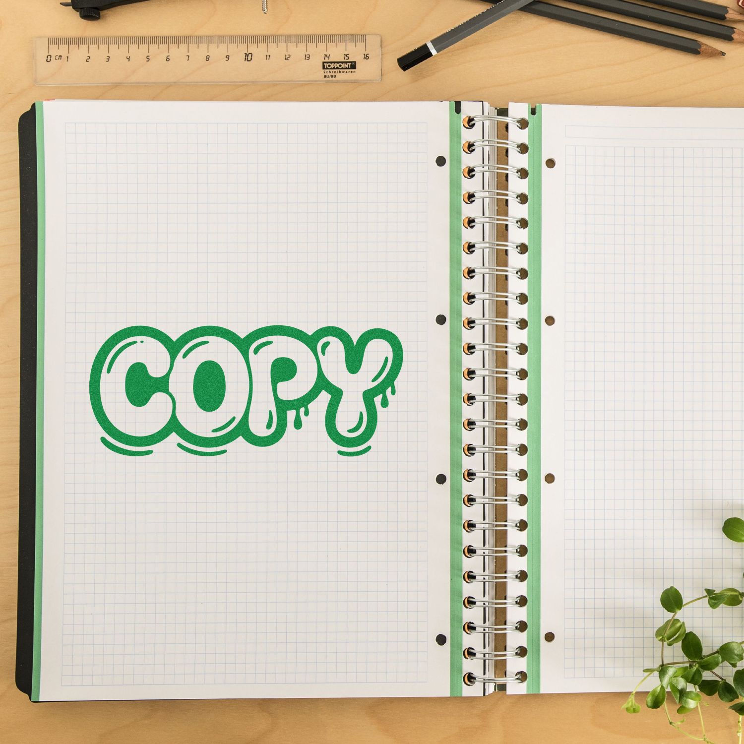 Green COPY rubber stamp on open notebook, ideal for marking duplicate office documents.