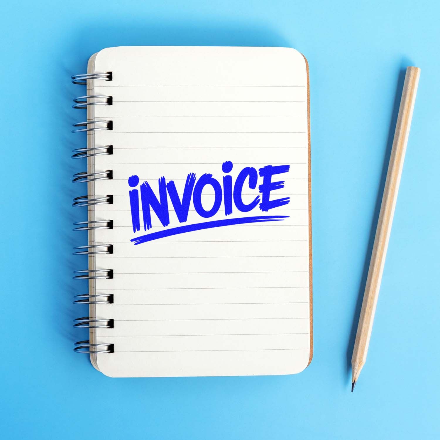 Blue invoice rubber stamp on a notebook, ideal for office bookkeeping, billing, and business paperwork.