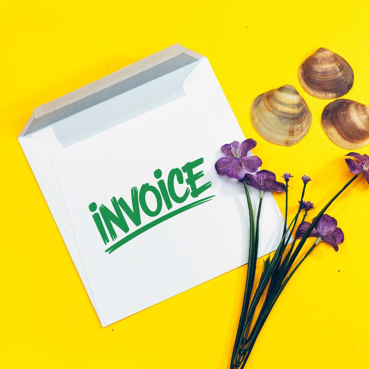Invoice rubber stamp impression on white envelope for business accounting and office use.