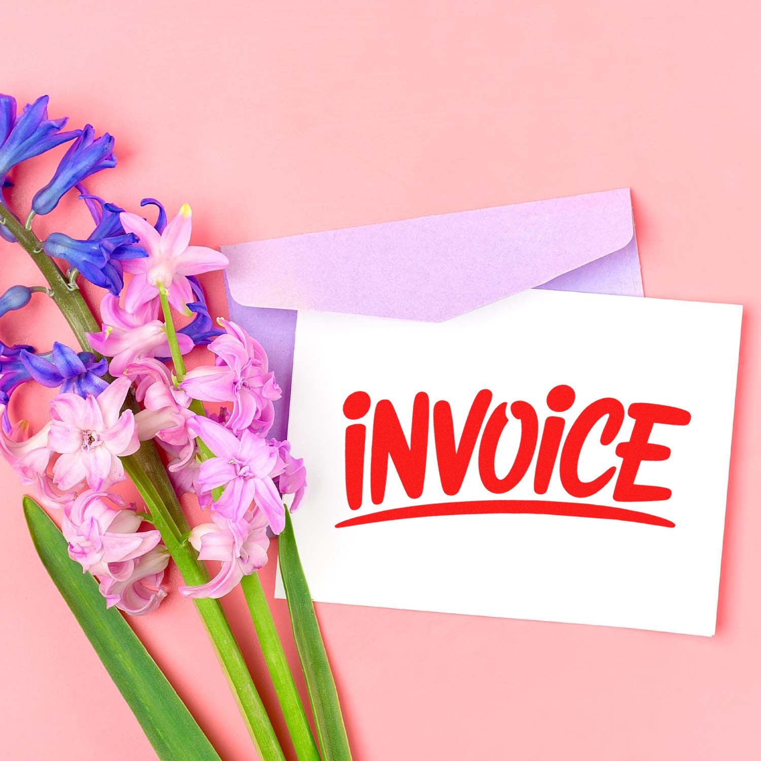 Invoice rubber stamp on envelope with flowers, ideal for business billing, office paperwork, and mail sorting.