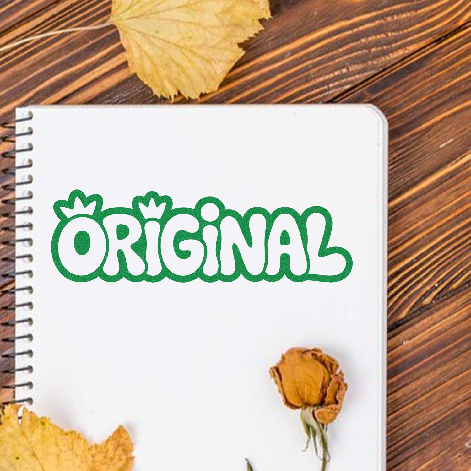 Original rubber stamp design in green bubble lettering on a notebook, ideal for custom crafts, branding, and stationery.