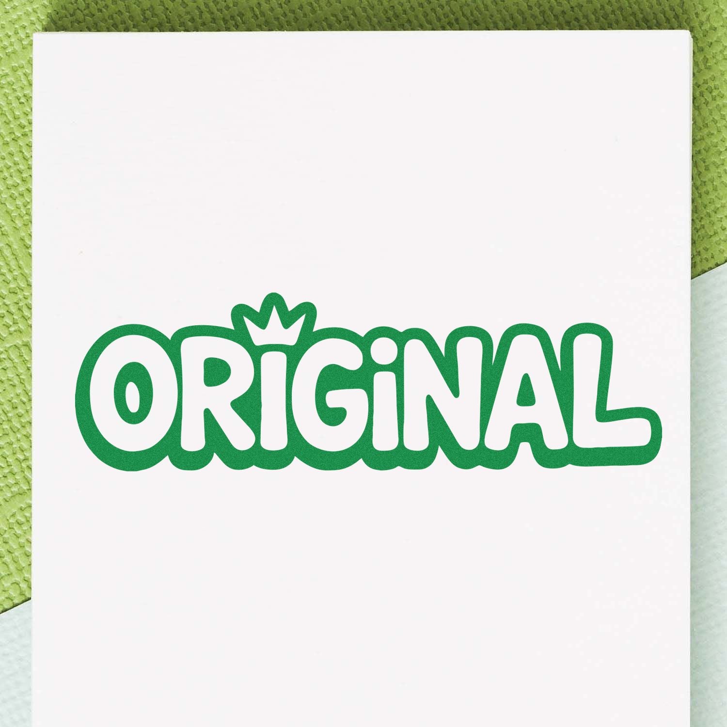 Green ORIGINAL rubber stamp design with crown accent on white paper, ideal for custom branding and handmade packaging.