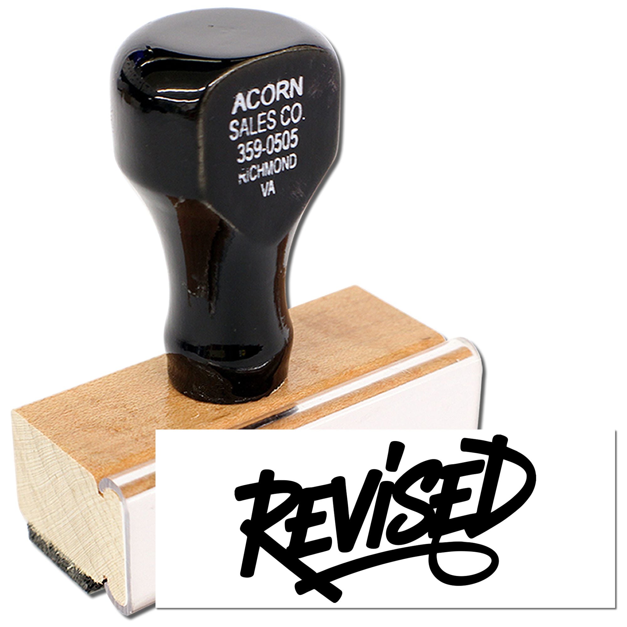 Custom wood handle rubber stamp for office use, creating a bold REVISED imprint on documents.