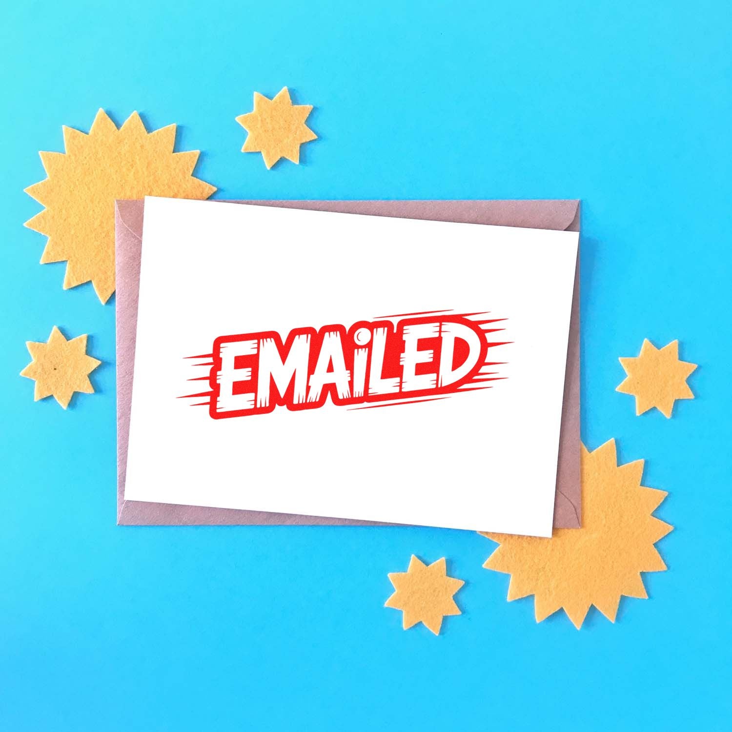 Red Emailed rubber stamp on envelope, used to mark outgoing mail or documents as sent.