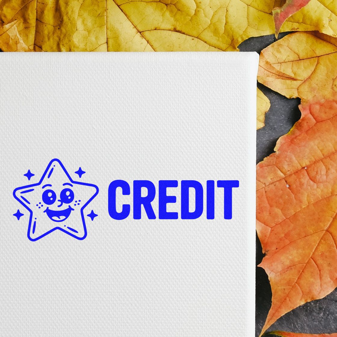 Blue credit rubber stamp with smiling star icon on textured white paper, styled with autumn leaves background.