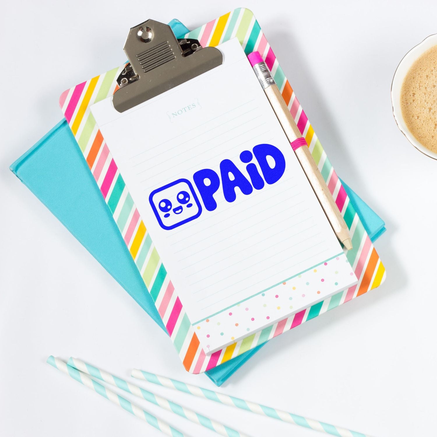 PAID rubber stamp on clipboard notepad with colorful stationery, ideal for office billing, invoices, and receipt tracking.