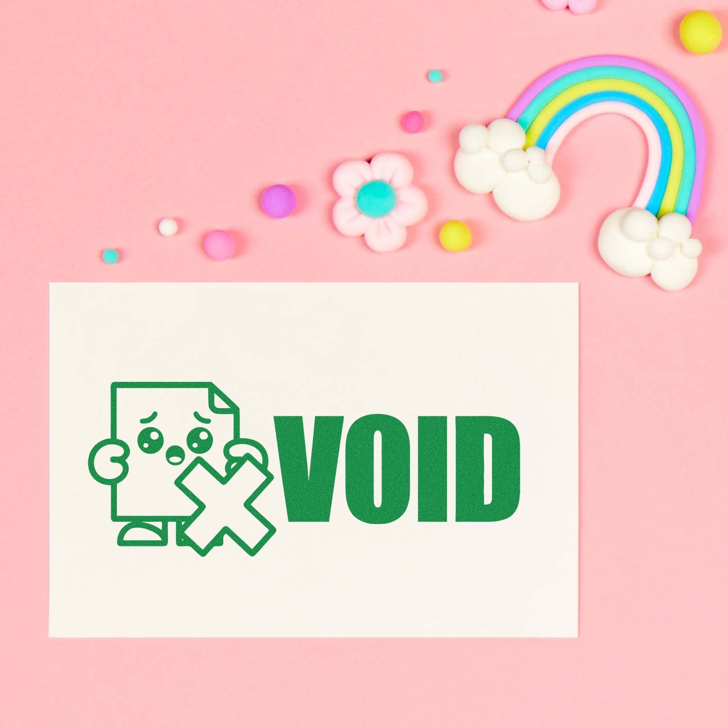 VOID rubber stamp graphic with sad document icon on white card, styled on a pink rainbow craft background.