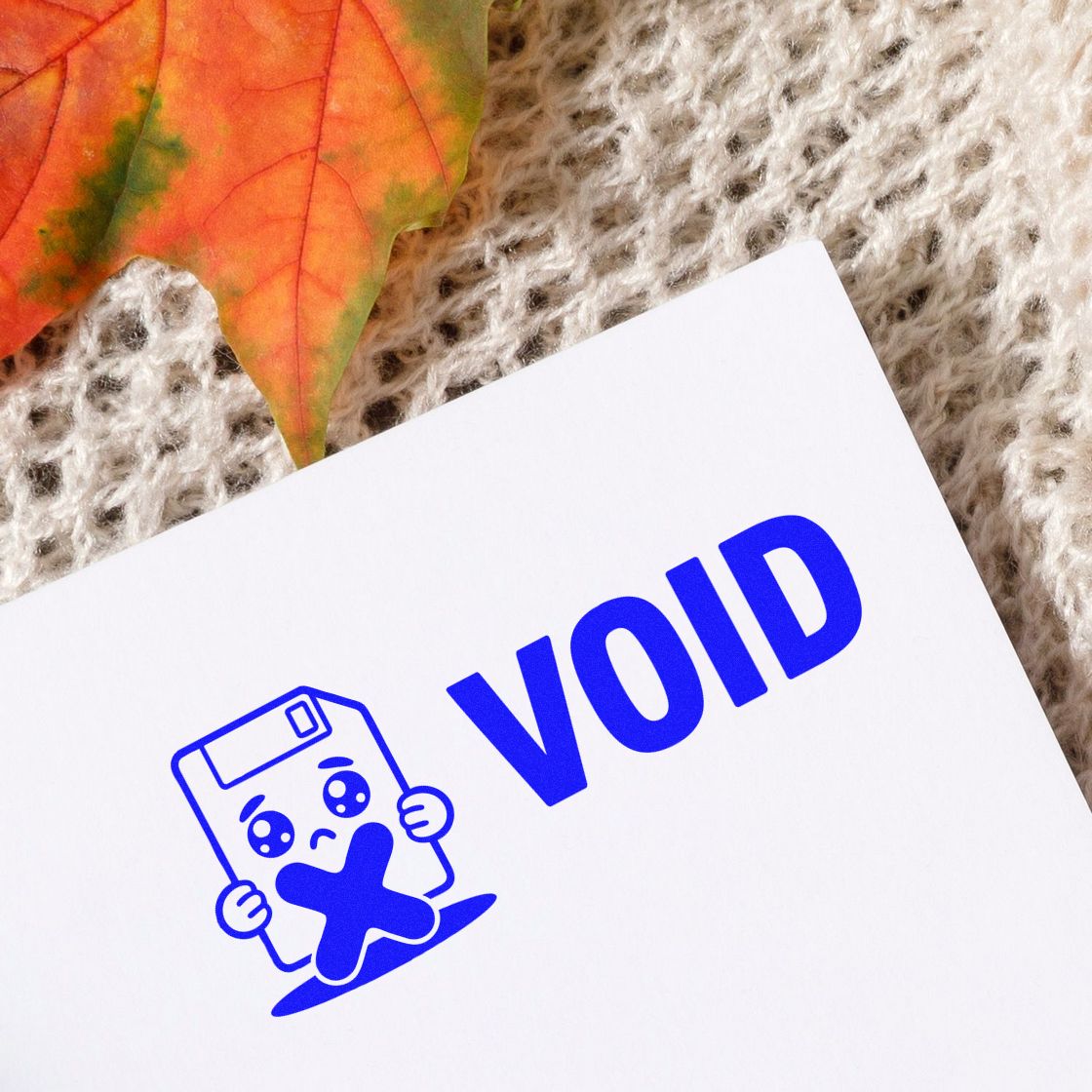 Blue VOID rubber stamp design with sad floppy disk icon for document cancellation and office approval marking.