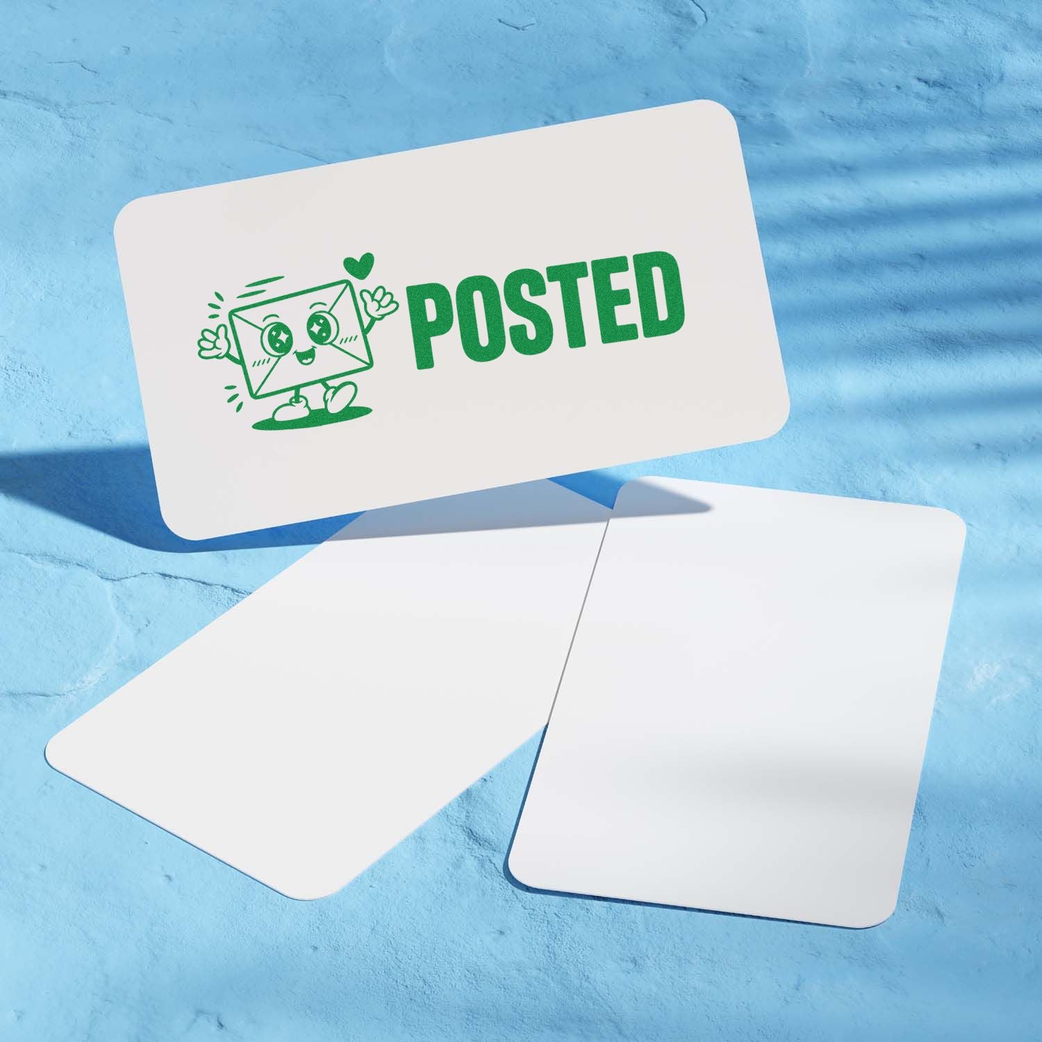 Green Posted rubber stamp with cute envelope mascot on a postcard, ideal for mail, shipping, and stationery branding.