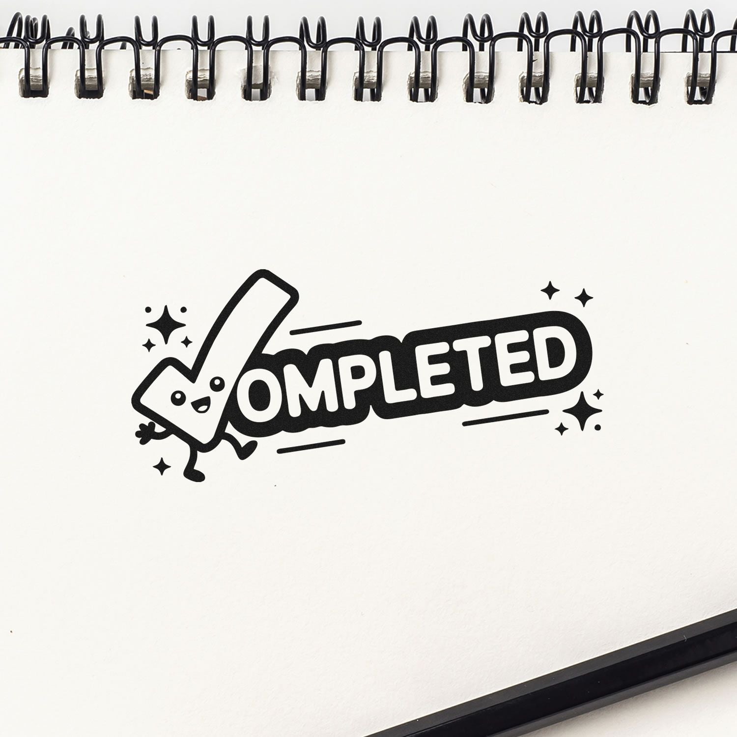 Completed rubber stamp with smiling checkmark on spiral notebook page, perfect for project status, planner, and office use.