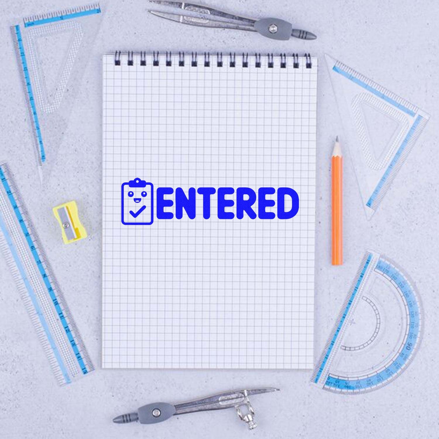 Entered rubber stamp design on notebook for office document tracking and record-keeping.
