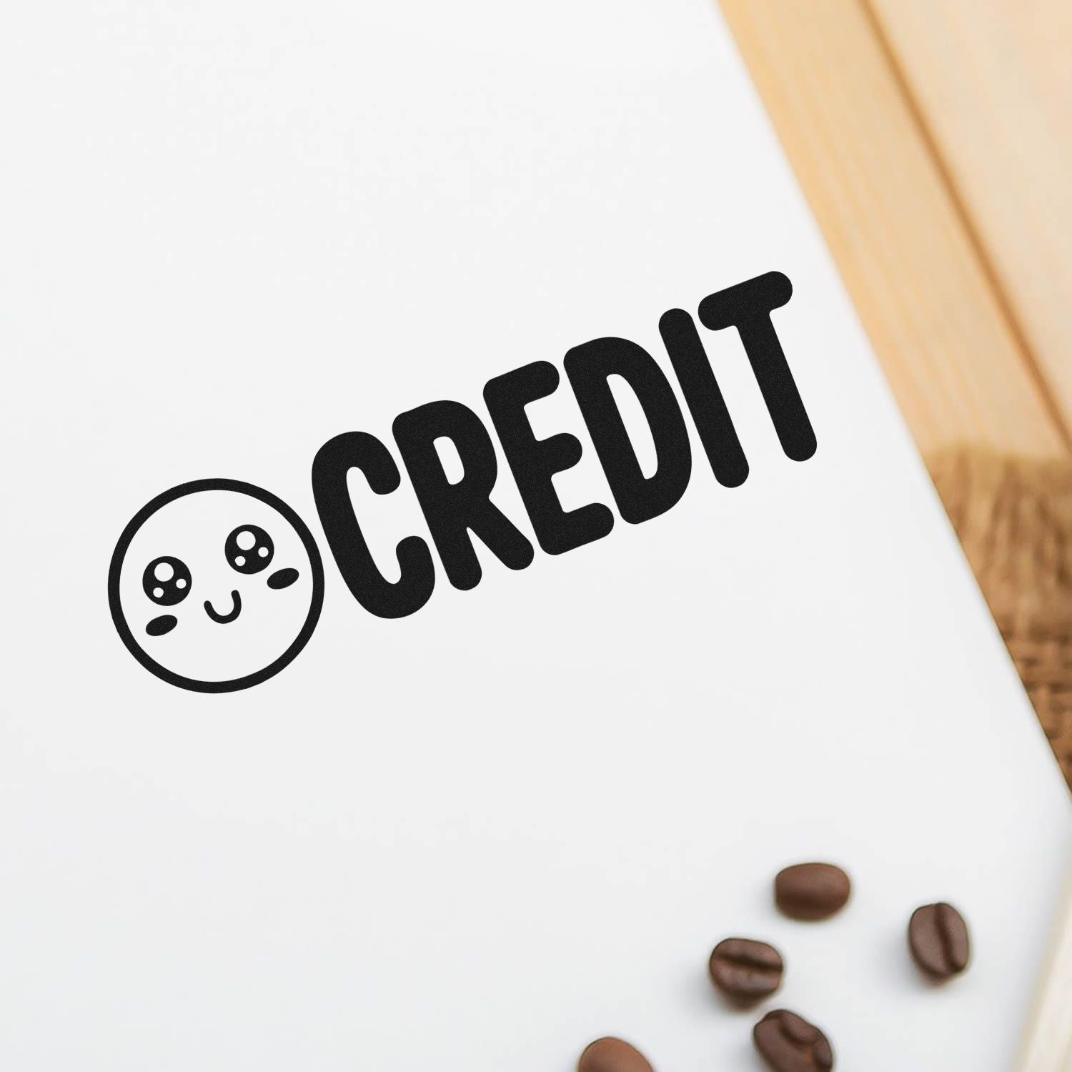 Custom credit rubber stamp with cute face icon on paper, ideal for coffee packaging, branding, and stationery.