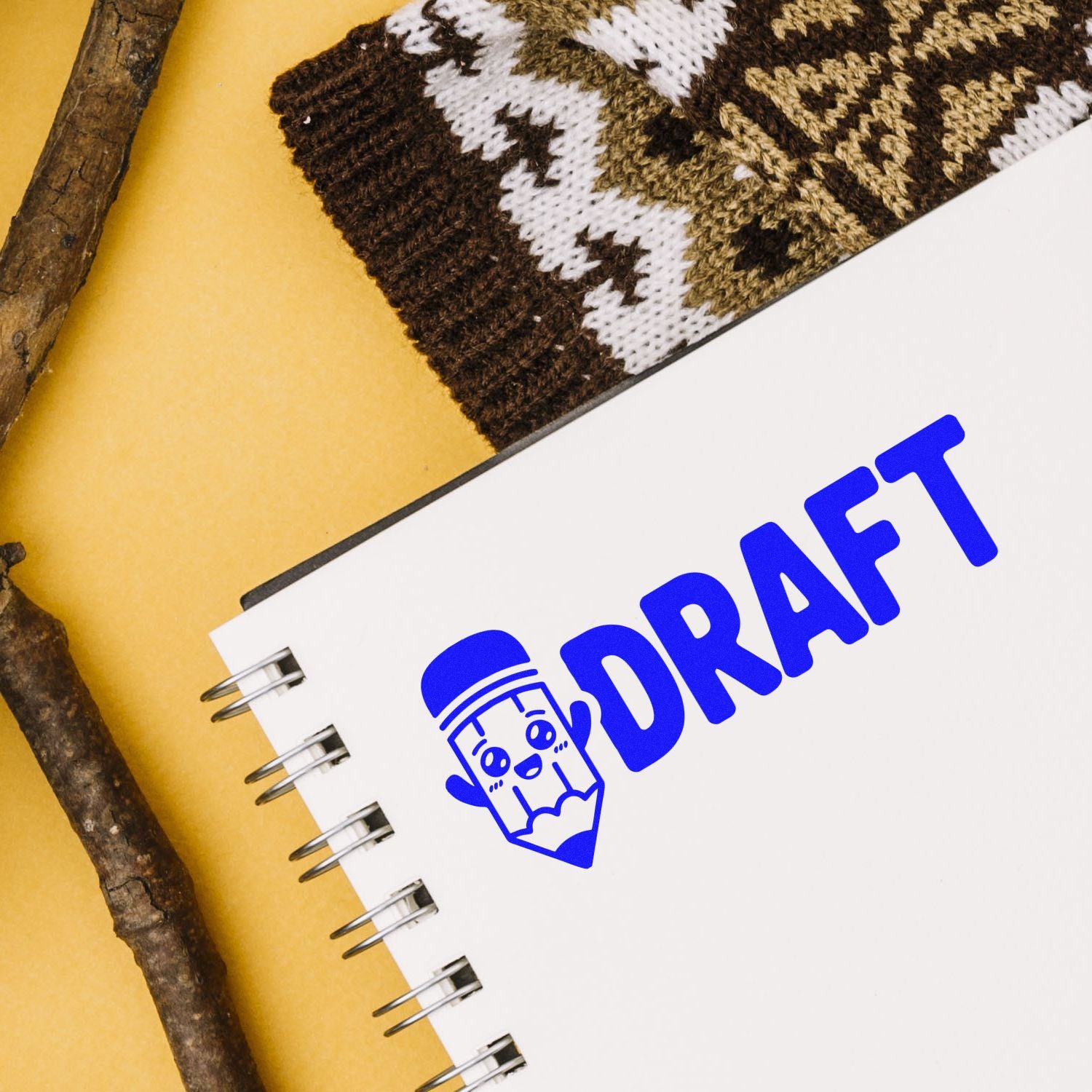 Blue DRAFT rubber stamp impression on a spiral notebook, perfect for document review, proofreading, and office filing.