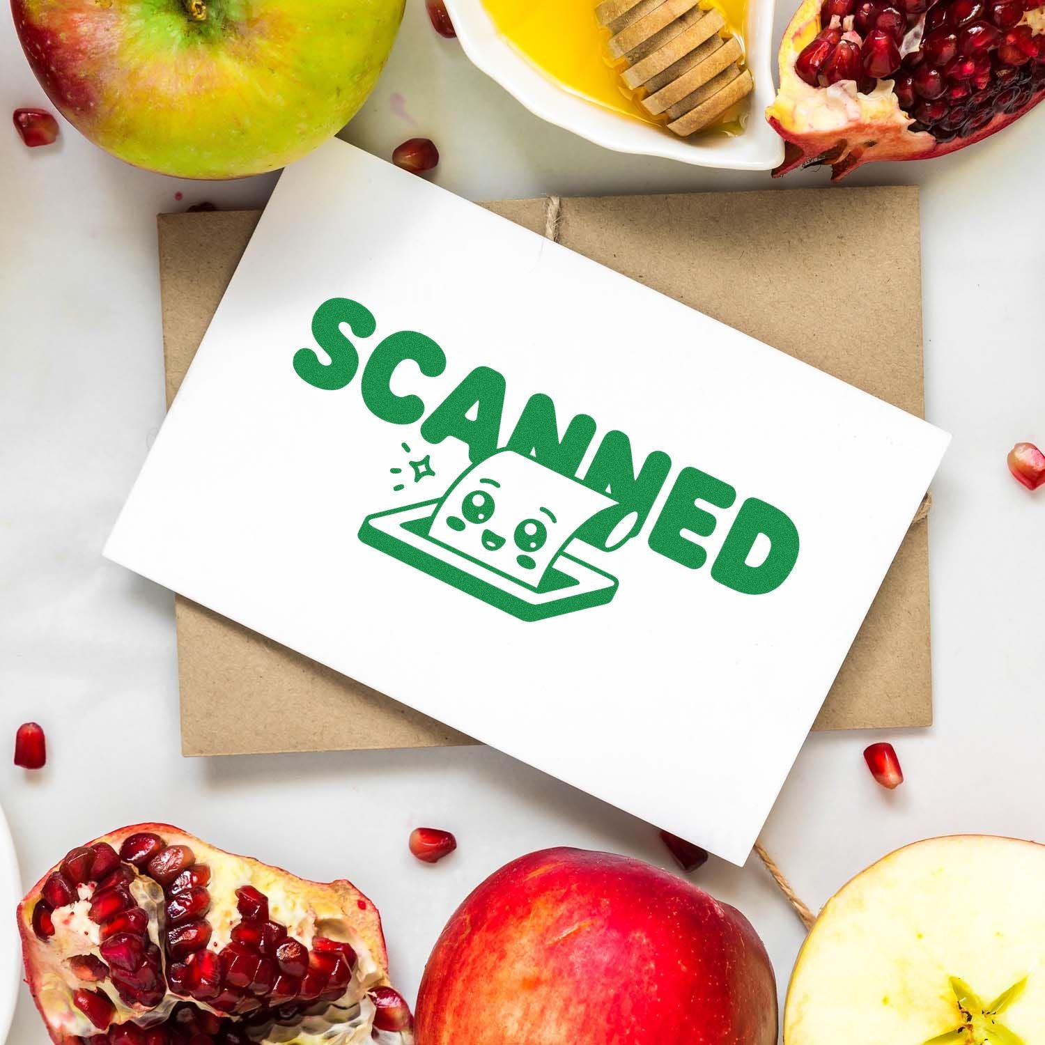 Green Scanned rubber stamp mockup on white card over kraft envelope with fruit flat lay background.